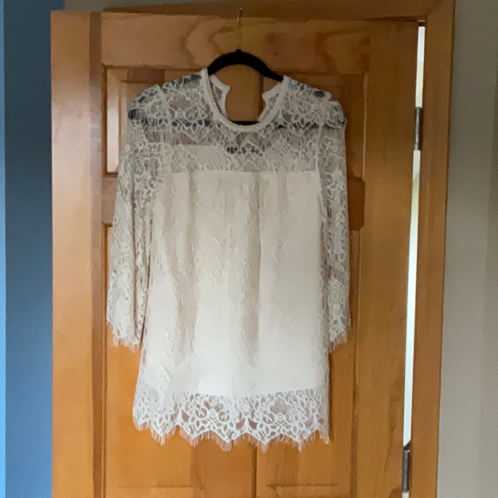 White/cream top with lace accents